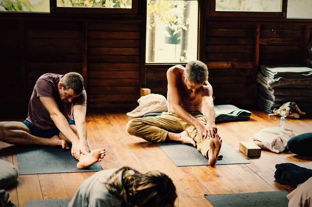 Partner yoga stretch during class