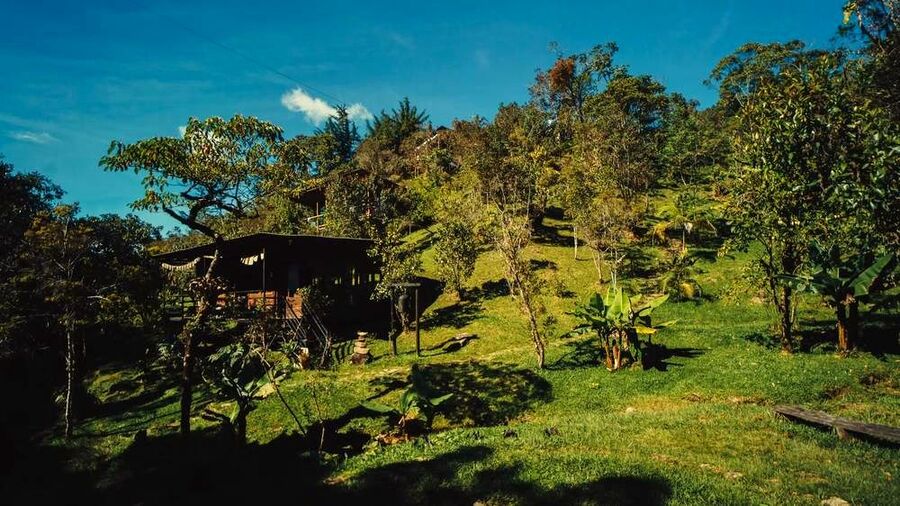 Cabin on the hillside under blue sky