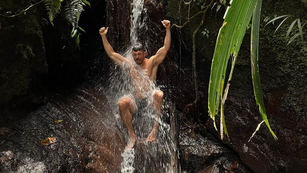 Guest cooling off under a waterfall