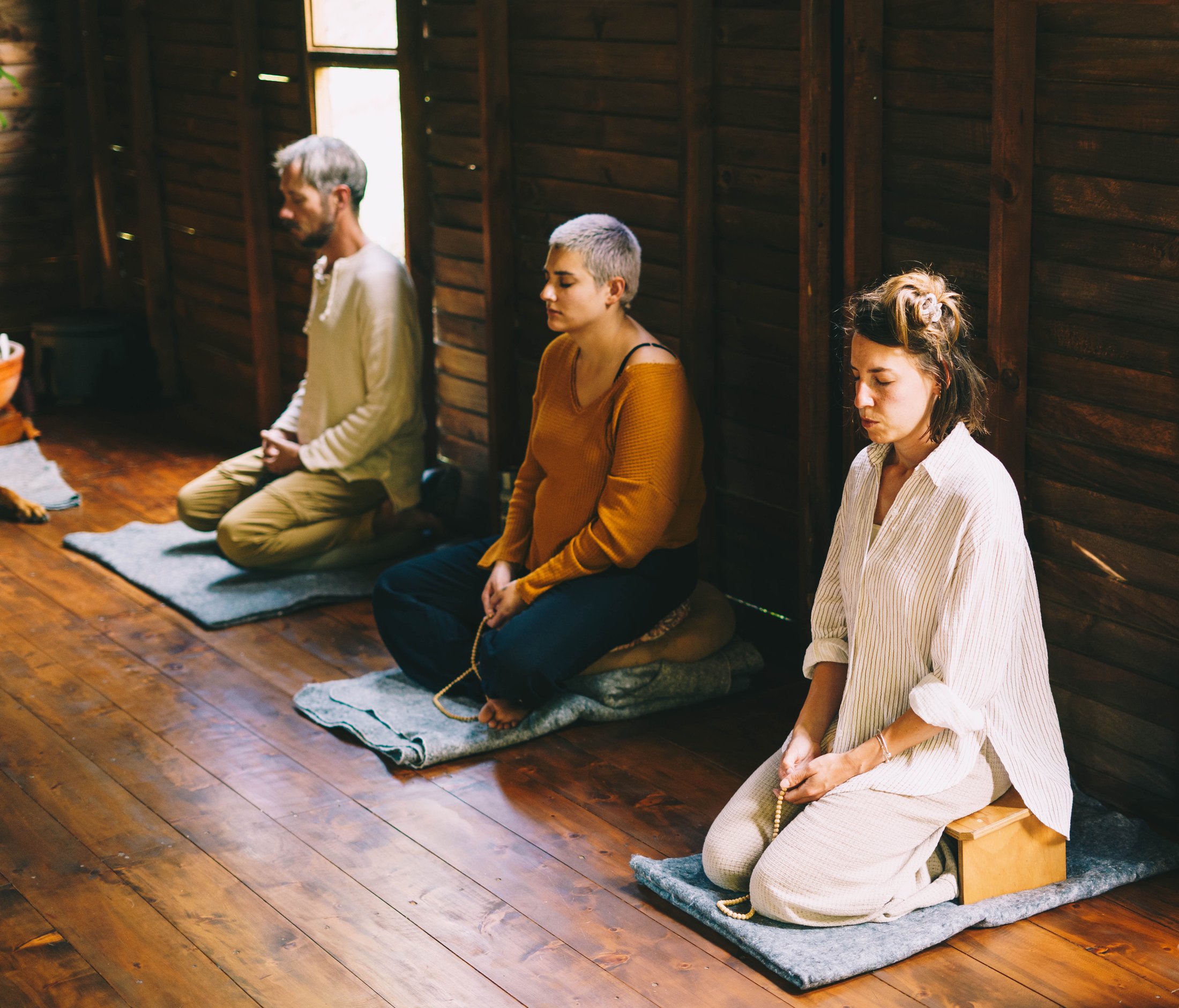 Group meditation session at La Casa de Loto with the teacher and dog at the front of the hall